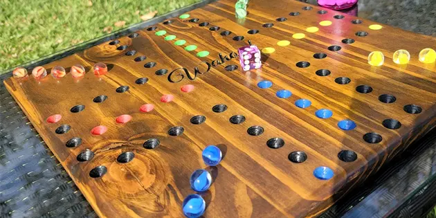 Wahoo game board layout with marbles and a single die Wahoo game board layout with marbles and a single die